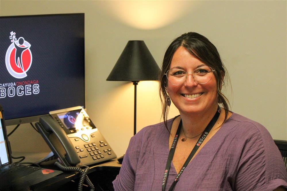  A headshot of Erica in front of her desk